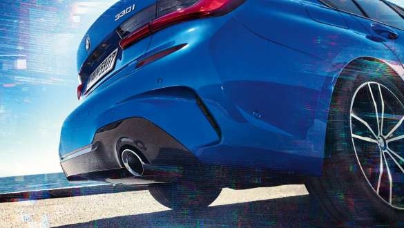 BMW 3. sērijas Sedan (G20), M sporta diferenciālis. Skats no sāna uz BMW 3. sērijas Sedan (G20) aizmuguri no apakšas.
