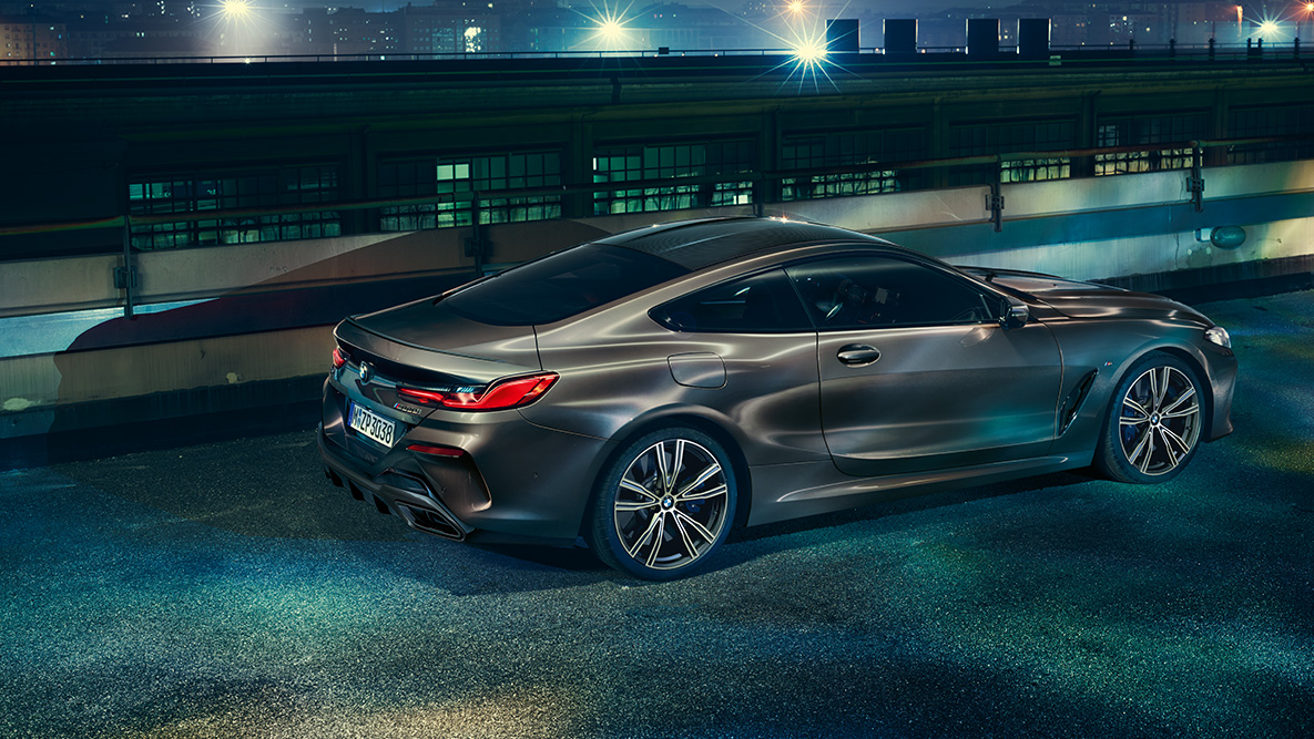 BMW 8. sērijas Coupé momentuzņēmums. BMW 8. sērijas Coupé ar BMW Individual aprīkojumu sānu momentuzņēmums naksnīgā pilsētā.