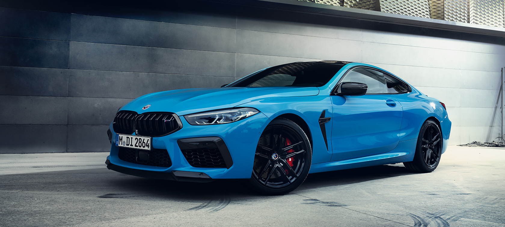 Jaunais BMW M8 Competition Coupé F92, LCI, atjaunināts, 2022, Daytona Beach Blue uni krāsa, trīs ceturtdaļu sānskats, stāvošs automobilis uz sienas fona