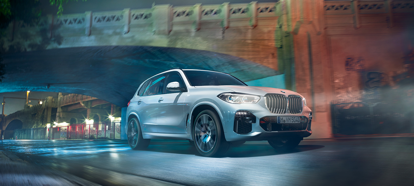 BMW X5 G05 2018, metāliska Mineral White krāsa, trīs ceturtdaļu skats no priekšpuses, naktī braucošs automobilis